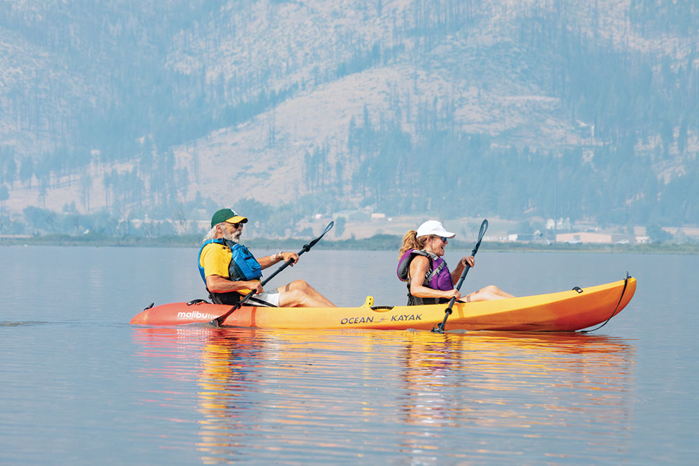 An older couple kayaking in a tandem kayak on Washoe Lake