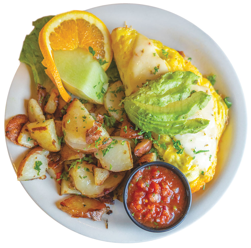 California omelet on a plate, with fried potato, avocado, salsa, and fruit