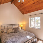 Farmhouse bedroom with high wooden ceiling