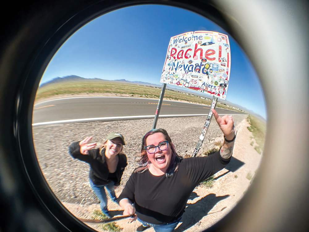 Ali (left) and Rachel (right) outside the 'Welcome to Rachel Nevada' sign. 