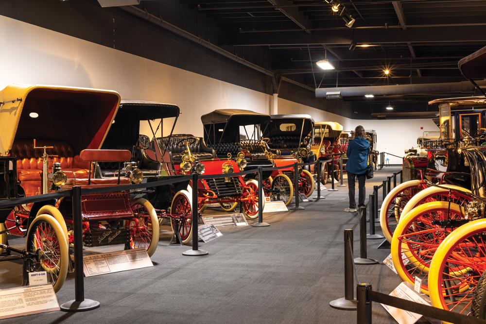 Woman looking at old cars.