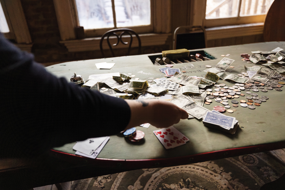 Hand putting a dollar bill down on a poker table at The Washoe Club in Virginia City.
