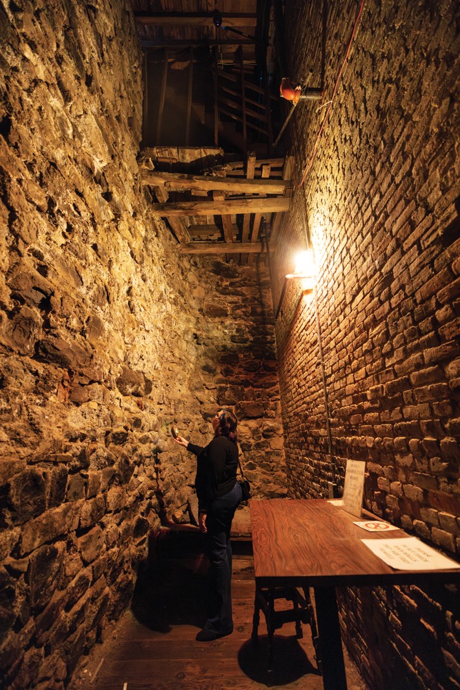 Person holding ghost hunting device inside the crypt at the Washoe Club in Virginia City. 
