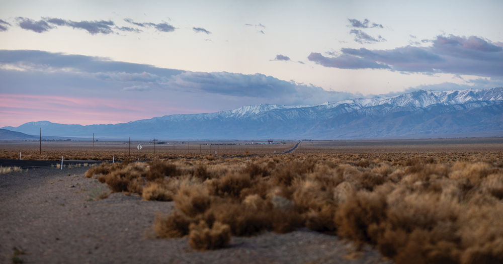 Shot of road leading towards Dyer with the White Mountains in the distance. 