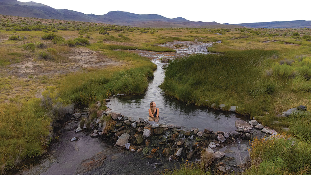 Woman soaking in Soldier Meadows Hot Springs