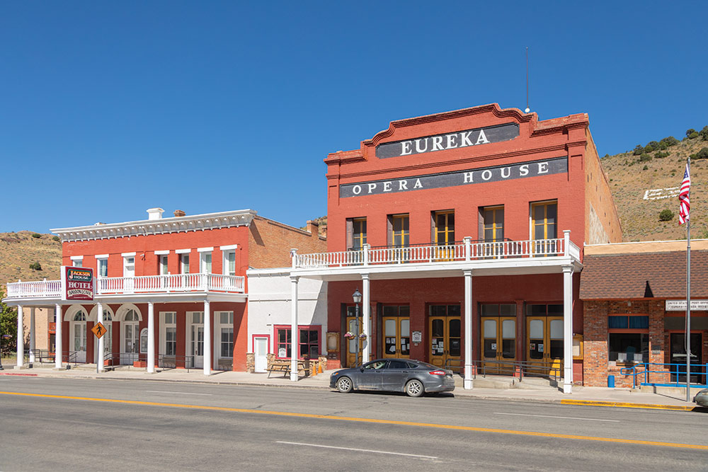 The Eureka Opera House, photographed from across the street, with mountains in the background.