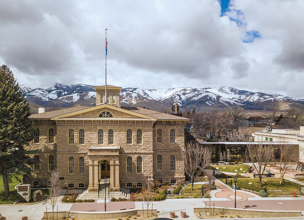 Drone photo of Carson City Mint with snow-capped mountains behind it