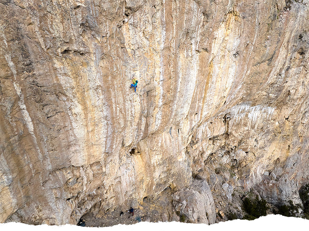 A rock climber scales a vertical wall of rock near Ely