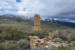 Man standing next to remains from Hamilton ghost town.