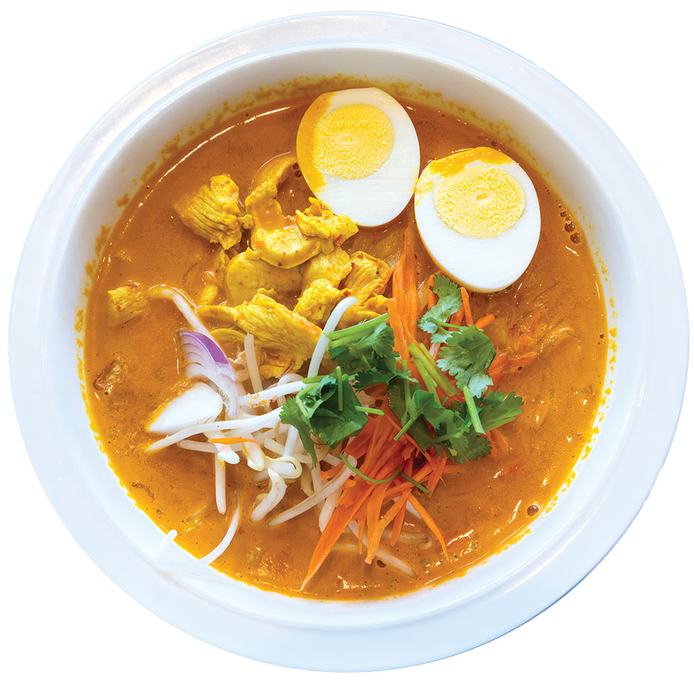 Thai yellow curry soup with chicken, boiled egg, shredded carrot, bean sprouts, onion, and cilantro