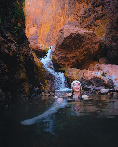 Woman soaking in Gold Strike Hot Springs