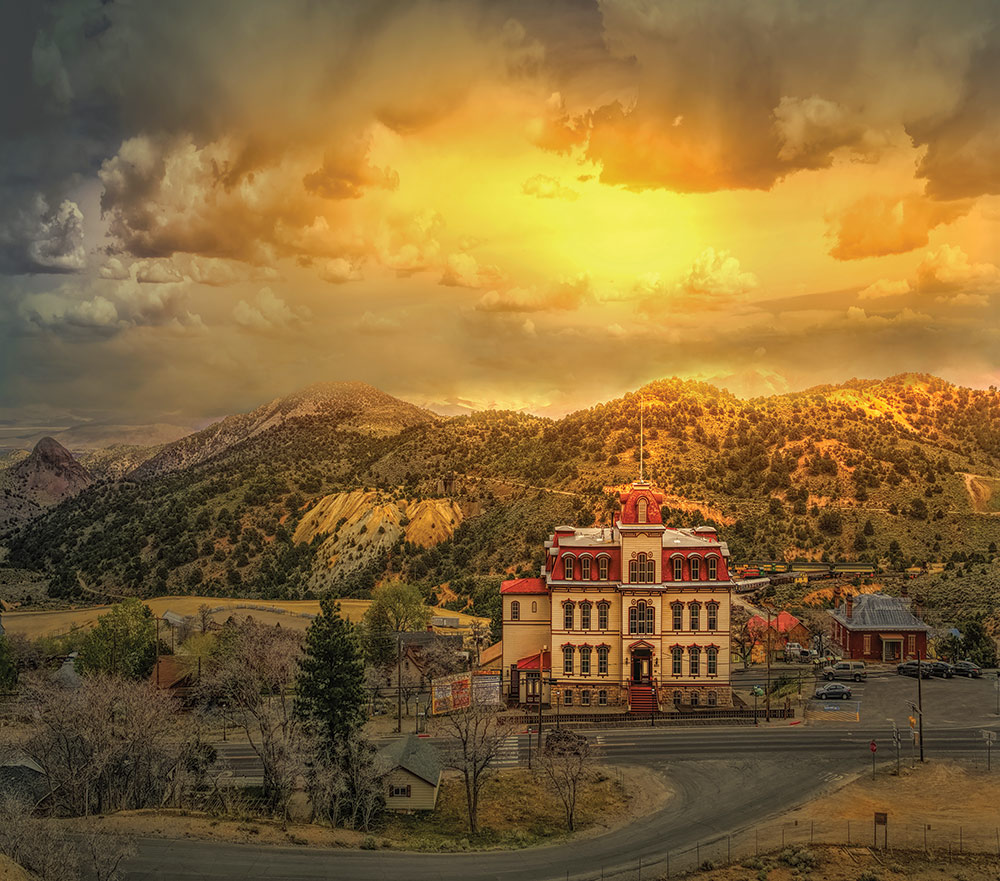 Fourth Ward School Museum, taken from the hill above. There is a golden sunset, and everything around the school is dusted in snow. Photo ©Liz Huntington