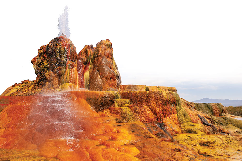 Water shoots out of one of the spouts of the very colorful Fly Geyser