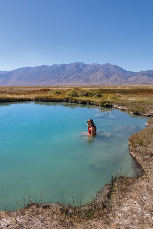 A woman soaks in Ruby Valley Hot Springs