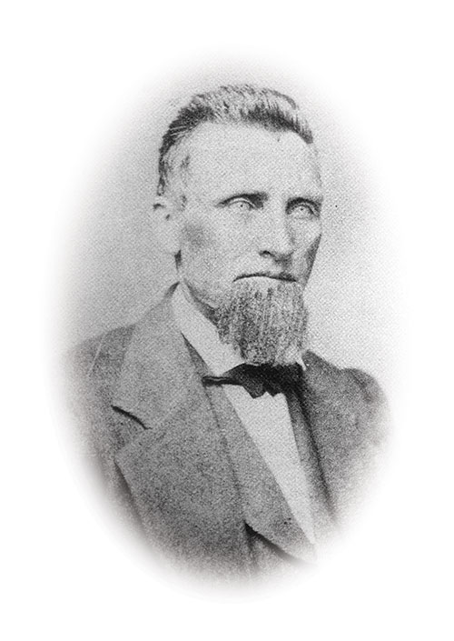 Historic black and white photo of Snowshoe Thompson, in a suit, bowtie, and with a beard.