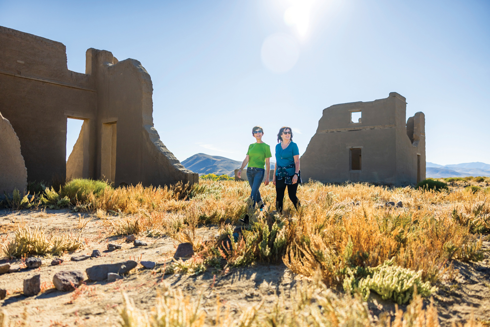 Two women walking along remains at Fort Churchill State Park.