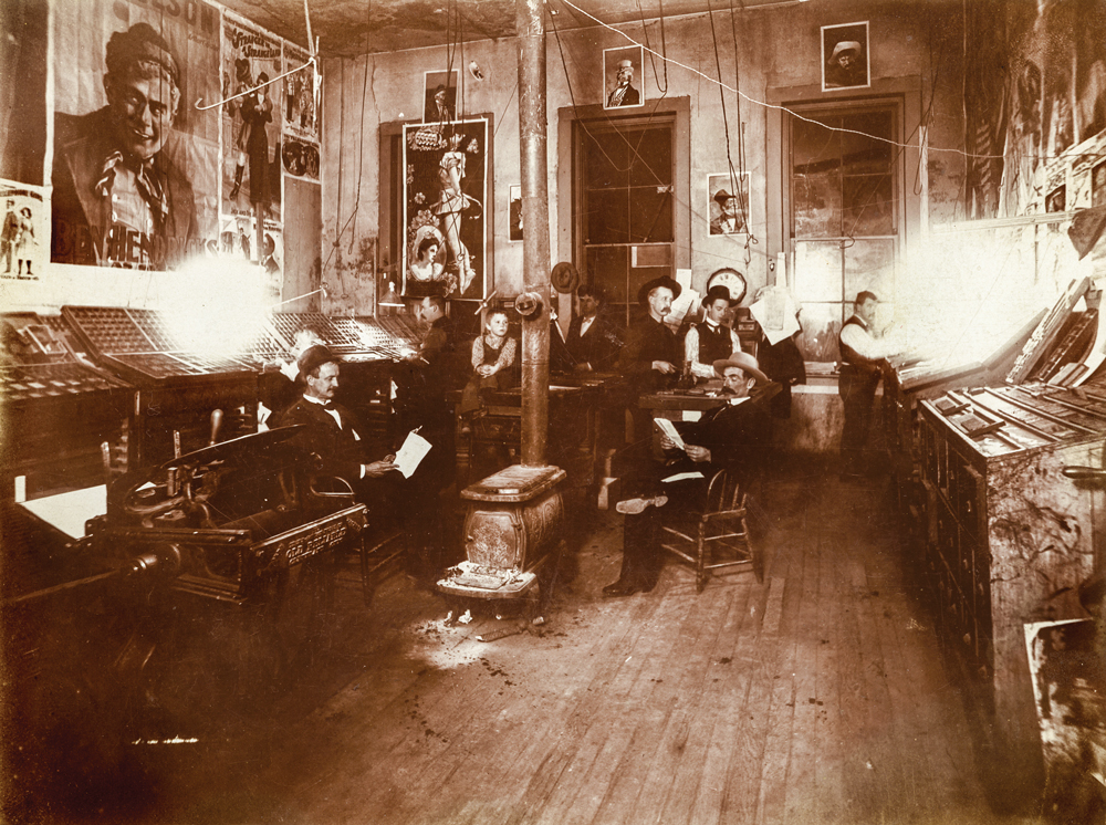 A group of men sitting in the pressroom of the "Territorial Enterprise" circa 1895.